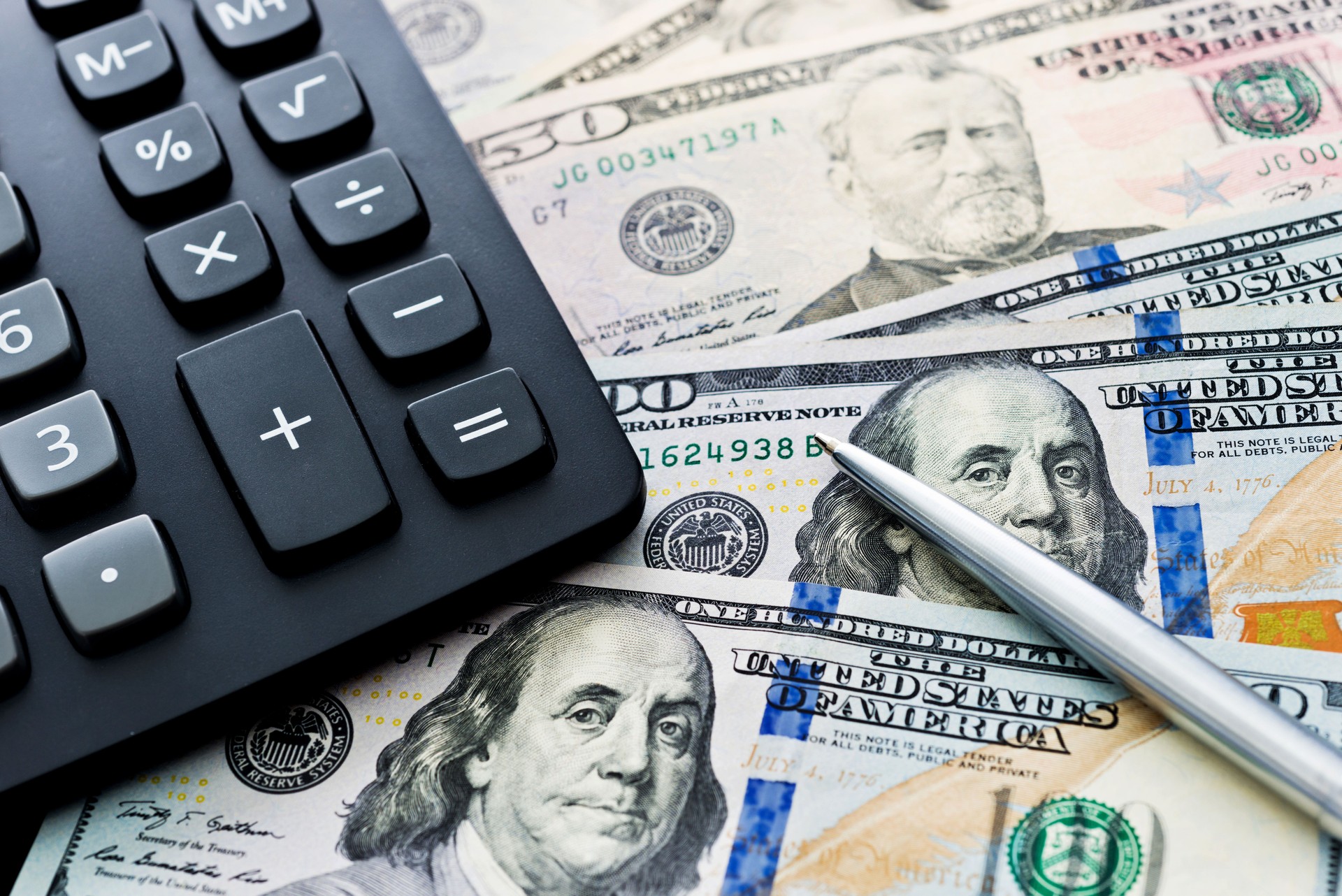 US dollar bills and calculator